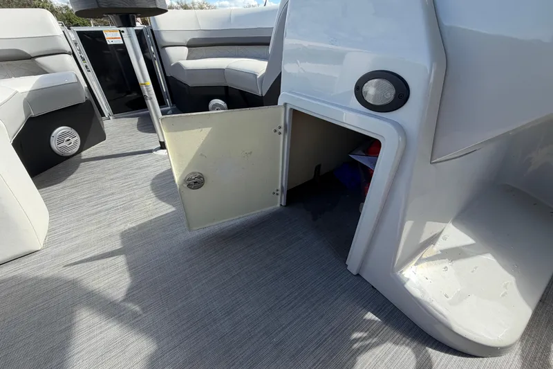 Slide: The Image of 2023 Lowe SS 210 boat interior with open storage compartment and seating area. - 27