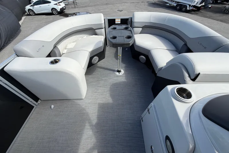 Slide: The Image of 2023 Lowe SS 210 pontoon boat interior with gray seating and cup holders. - 28