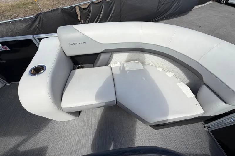Slide: The Image of 2023 Lowe SS 210 boat interior with gray cushioned seating and cup holder. - 30