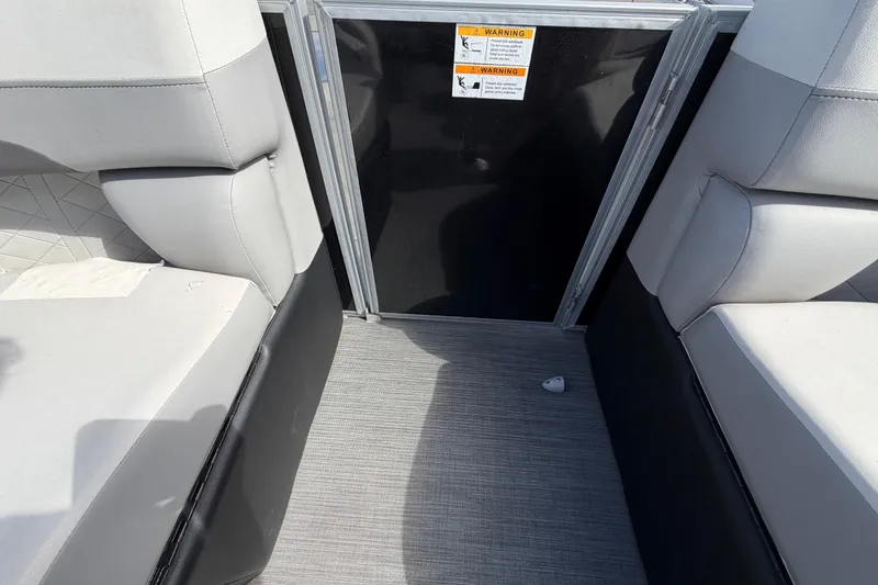 Slide: The Image of 2023 Lowe SS 210 boat interior with gray seating and warning labels. - 31