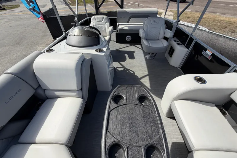 Slide: The Image of 2023 Lowe SS 210 pontoon boat interior with plush seating and modern design. - 34