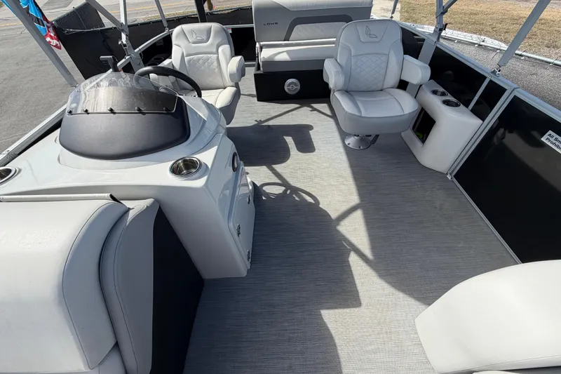 Slide: The Image of 2023 Lowe SS 210 pontoon boat interior with modern seating and steering console. - 36