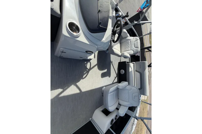 Slide: The Image of 2023 Lowe SS 210 boat interior with plush seating and modern steering console. - 38
