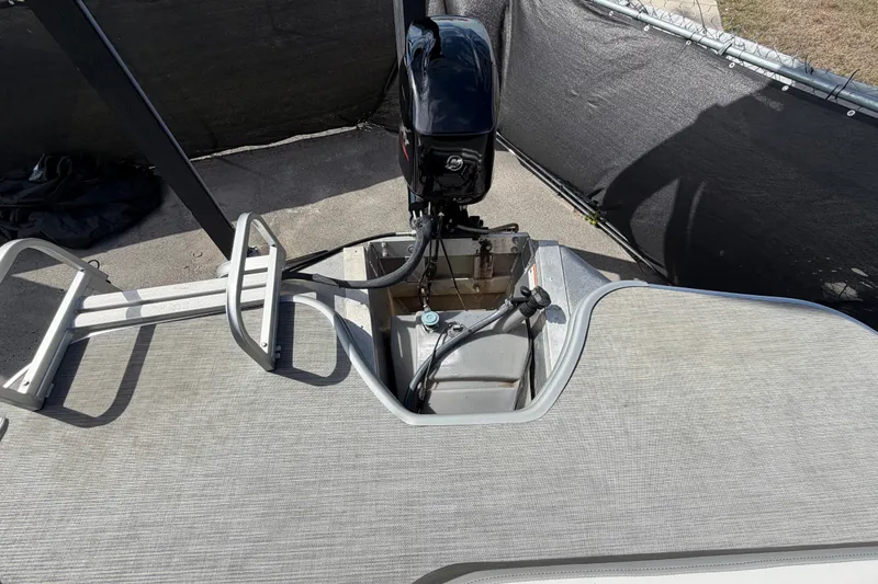 Slide: The Image of 2023 Lowe SS 210 boat with motor and ladder, rear deck view. - 44