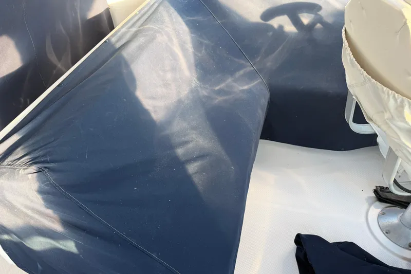 Slide: The Image of 1999 Bayliner 4788 Pilot House Motoryacht deck with protective covers and seating. - 10