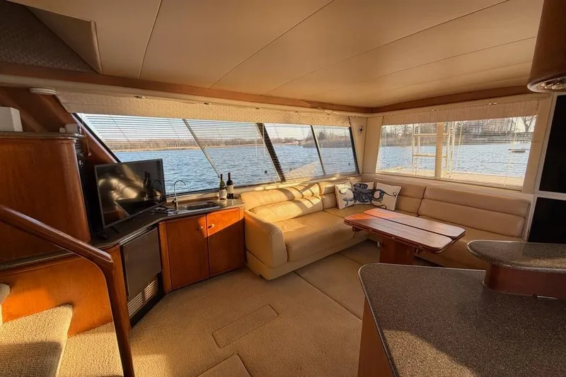 Slide: The Image of Interior of 1999 Bayliner 4788 Pilot House Motoryacht with cozy seating and scenic water view. - 16