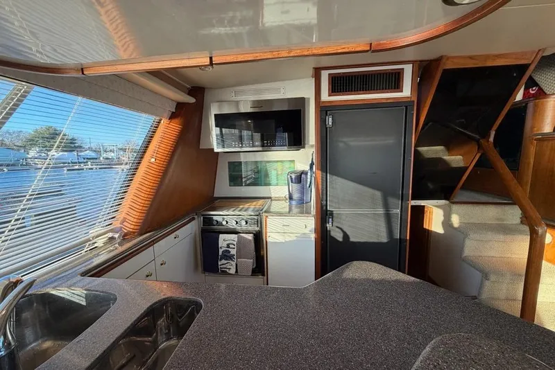 Slide: The Image of Interior of 1999 Bayliner 4788 Pilot House Motoryacht with kitchen and stairs. - 17