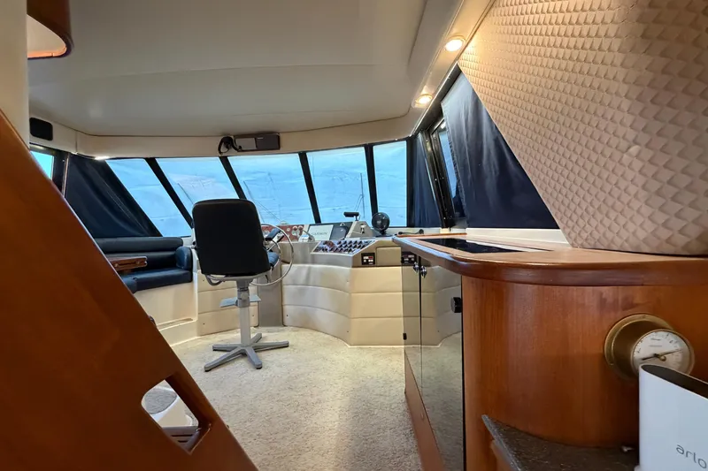 Slide: The Image of Interior of 1999 Bayliner 4788 Pilot House Motoryacht with helm station and seating area. - 19