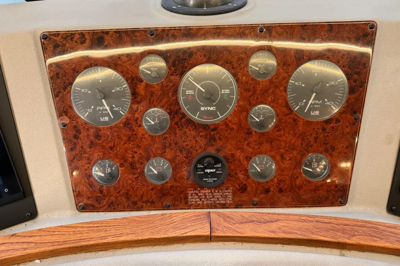 Slide: The Image of Dashboard of a 1999 Bayliner 4788 Pilot House Motoryacht with various gauges and controls. - 22