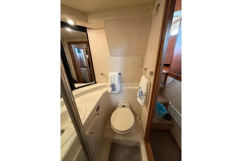 Slide: The Image of Bathroom interior of 1999 Bayliner 4788 Pilot House Motoryacht, featuring toilet and sink. - 28