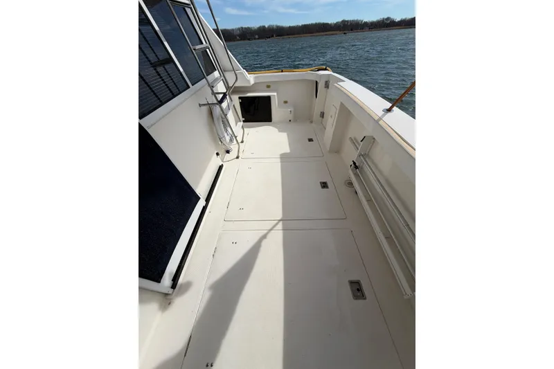 Slide: The Image of 1999 Bayliner 4788 Pilot House Motoryacht deck with open water view. - 3