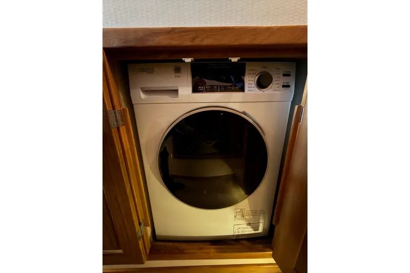 Slide: The Image of Washing machine inside 1999 Bayliner 4788 Pilot House Motoryacht wooden cabinet. - 30