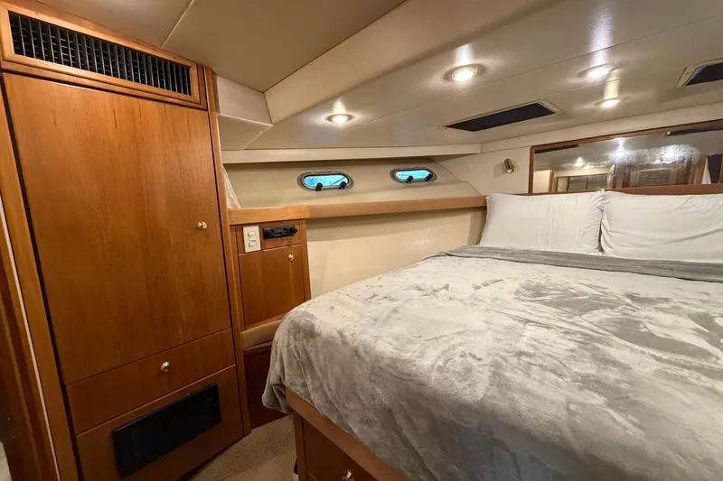 Slide: The Image of Luxurious bedroom interior of 1999 Bayliner 4788 Pilot House Motoryacht with wood cabinetry. - 31