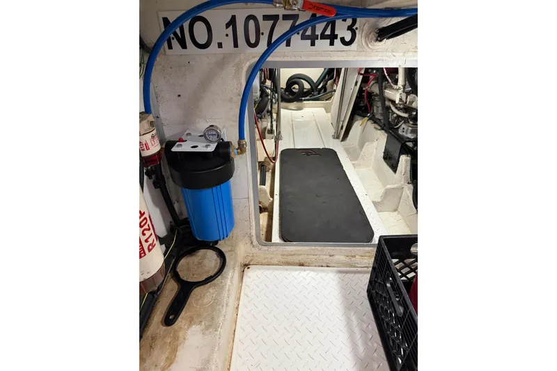 Slide: The Image of Engine room of 1999 Bayliner 4788 Pilot House Motoryacht with equipment and blue hose. - 37