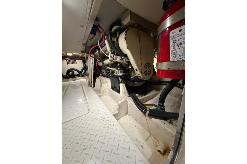 Slide: The Image of Engine room of 1999 Bayliner 4788 Pilot House Motoryacht with visible machinery and fire extinguisher. - 39