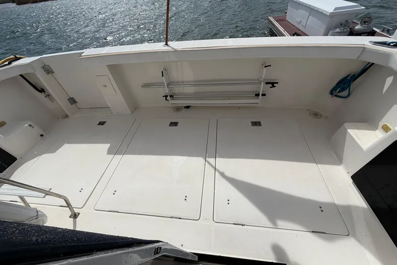 Slide: The Image of 1999 Bayliner 4788 Pilot House Motoryacht deck with storage compartments and railing. - 4
