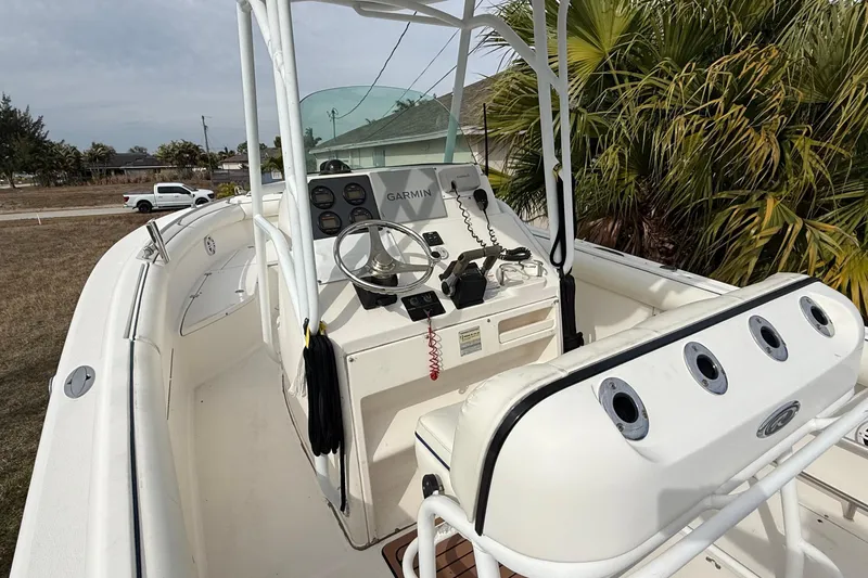 Slide: The Image of 2004 Rabalo 265 boat interior with steering wheel and Garmin navigation system. - 10