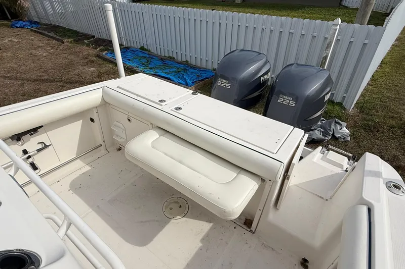Slide: The Image of 2004 Rabalo 265 boat interior with Yamaha 225 engines, white seating, and storage compartments. - 11