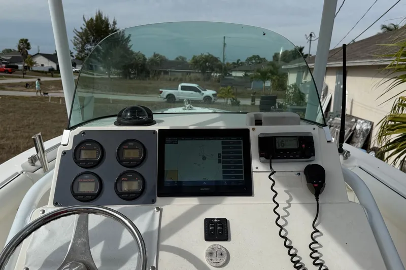 Slide: The Image of 2004 Rabalo 265 boat dashboard with navigation instruments and steering wheel. - 4