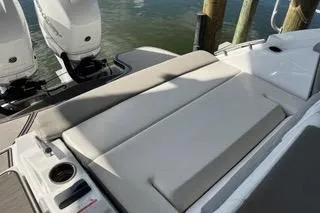 Slide: The Image of 2023 Four Winns H350 OB boat with cushioned seating and dual outboard motors. - 11