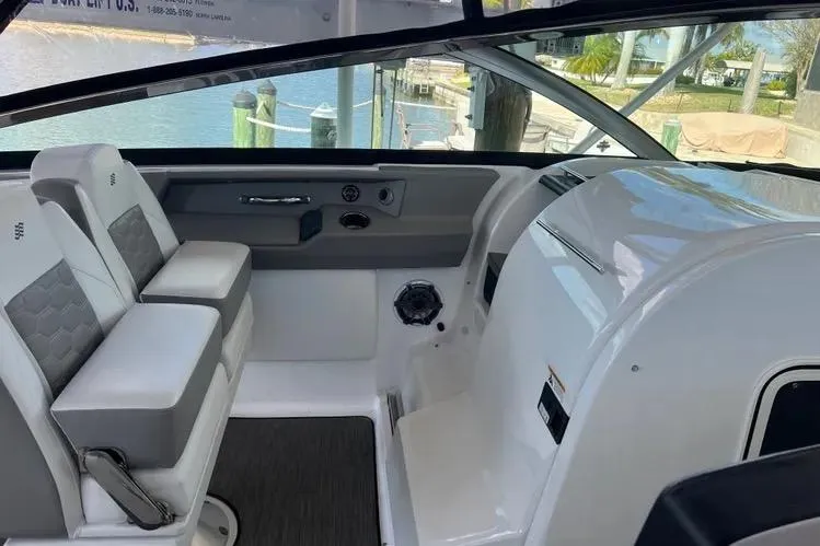 Slide: The Image of 2023 Four Winns H350 OB boat interior with modern seating and sleek design. - 13