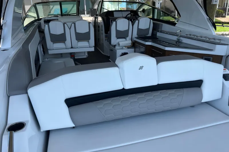 Slide: The Image of 2023 Four Winns H350 OB boat interior with luxurious seating and modern amenities. - 14