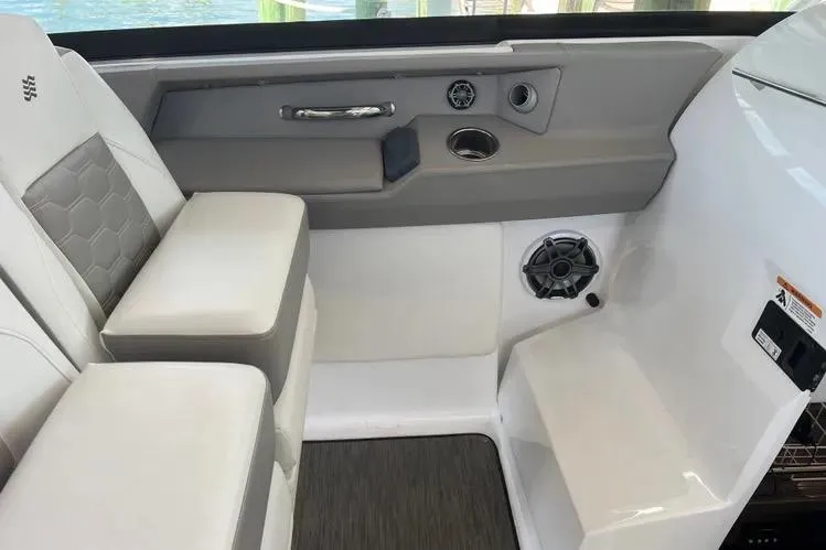 Slide: The Image of 2023 Four Winns H350 OB boat interior with cushioned seating and modern design elements. - 16