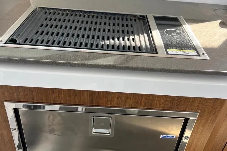 Slide: The Image of Outdoor grill and storage on 2023 Four Winns H350 OB boat. - 19