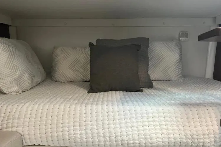 Slide: The Image of Cozy cabin bed in 2023 Four Winns H350 OB boat with decorative pillows. - 25