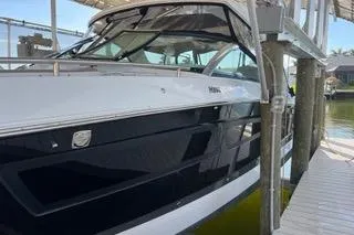 Slide: The Image of 2023 Four Winns H350 OB boat docked, showcasing sleek design and modern features. - 6