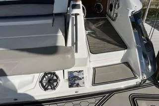 Slide: The Image of 2023 Four Winns H350 OB boat interior with seating and speaker detail. - 7