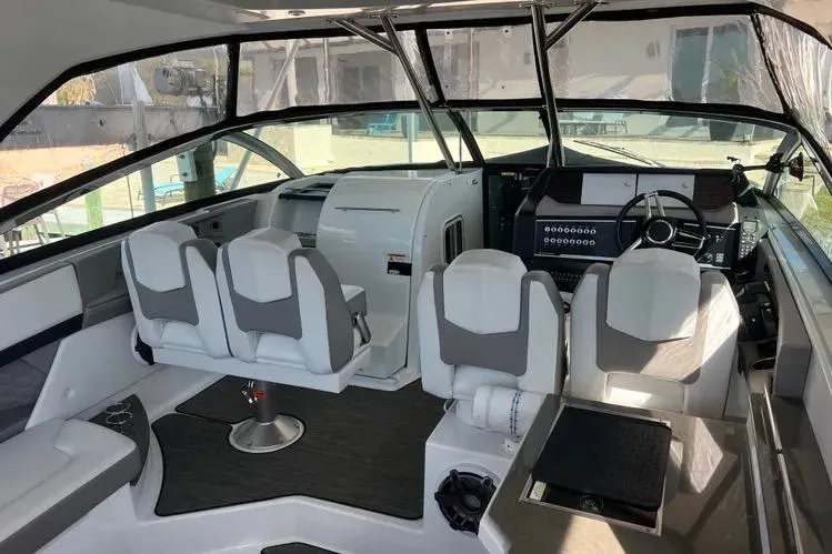 Slide: The Image of 2023 Four Winns H350 OB boat interior with modern seating and control panel. - 8