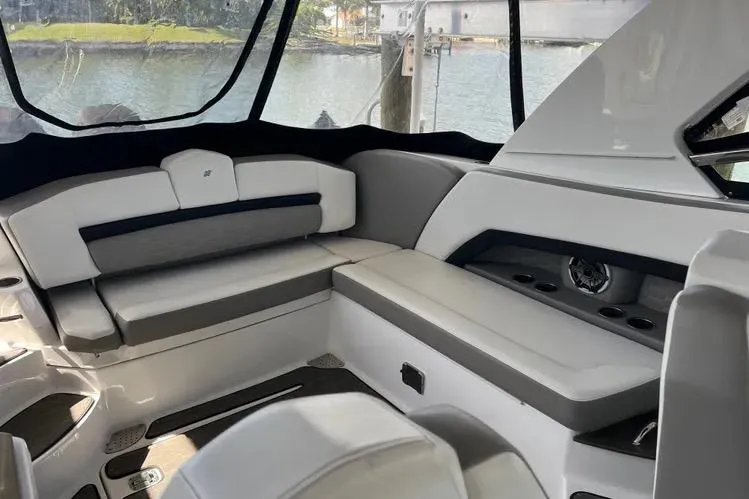 Slide: The Image of Interior of 2023 Four Winns H350 OB boat with sleek seating and modern design. - 9