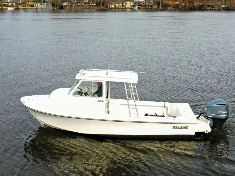 Slide: The Image of 1997 May-Craft 2300 Pilot boat on trailer outdoors. - 14