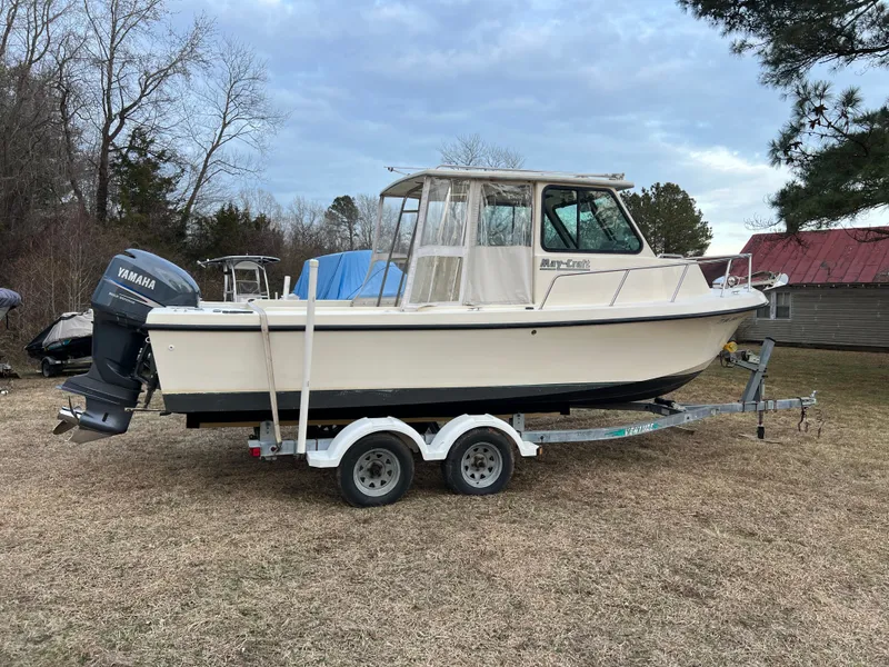 Slide: The Image of 1997 May-Craft 2300 Pilot boat on trailer outdoors. - 5
