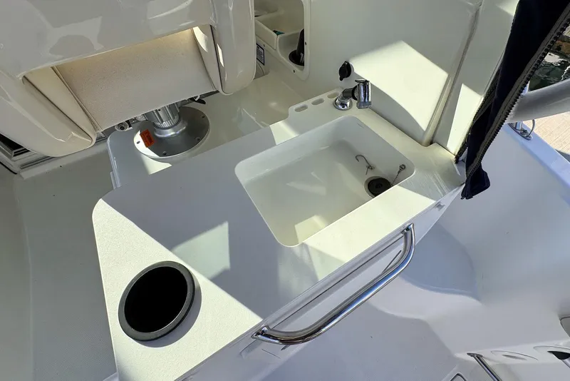 Slide: The Image of 2016 Boston Whaler 285 Conquest boat sink and seating area detail. - 10