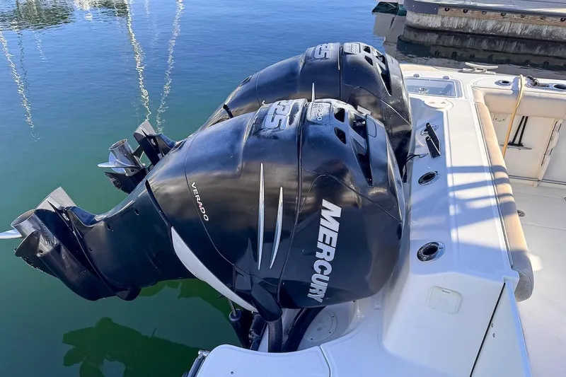 Slide: The Image of Twin Mercury Verado engines on a 2016 Boston Whaler 285 Conquest boat at the dock. - 11