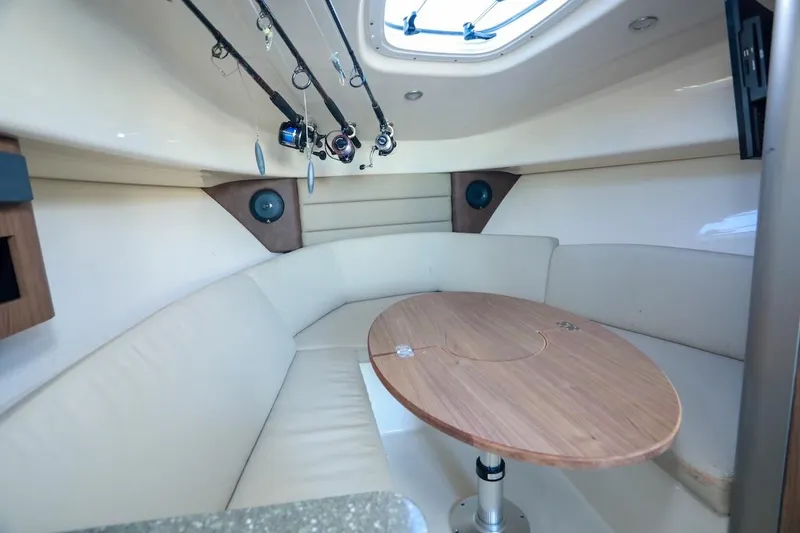 Slide: The Image of Interior of 2016 Boston Whaler 285 Conquest with cozy seating and fishing rods. - 12