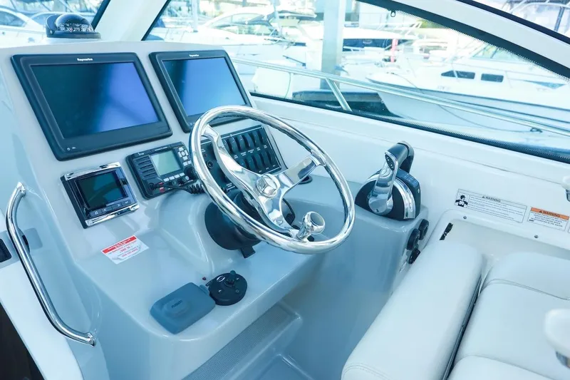 Slide: The Image of 2016 Boston Whaler 285 Conquest helm with dual screens and modern controls. - 2