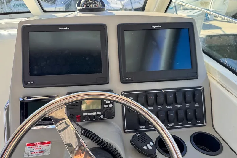 Slide: The Image of Helm of 2016 Boston Whaler 285 Conquest with dual Raymarine displays and controls. - 5