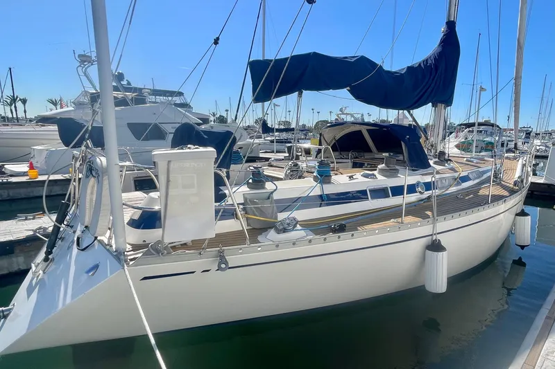 The Image of 1981 Nautor Swan cutter sailboat docked at marina under clear blue sky. - 0