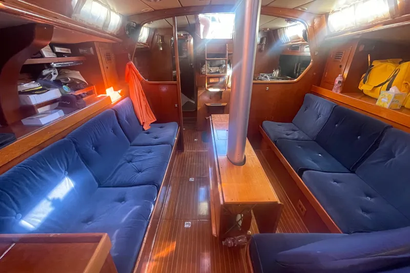 Slide: The Image of Interior of 1981 Nautor Swan cutter with blue seating and wooden finishes. - 10