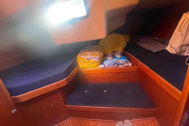 Slide: The Image of Cozy cabin interior of 1981 Nautor Swan cutter with wooden finish and storage. - 18