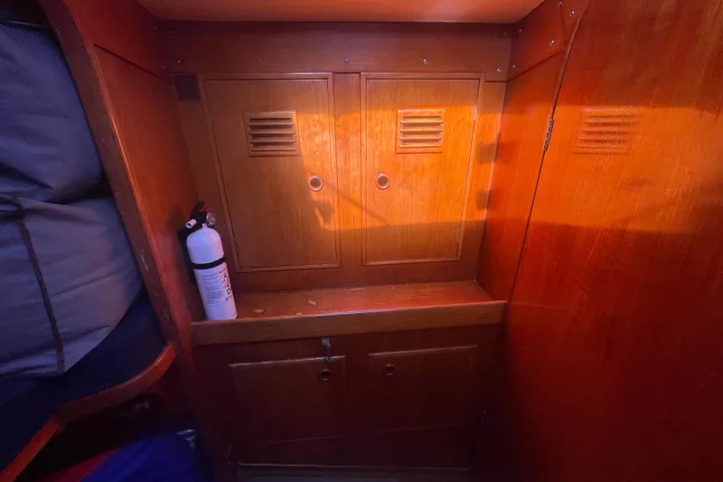 Slide: The Image of Wooden interior of 1981 Nautor Swan cutter with storage cabinets and fire extinguisher. - 20