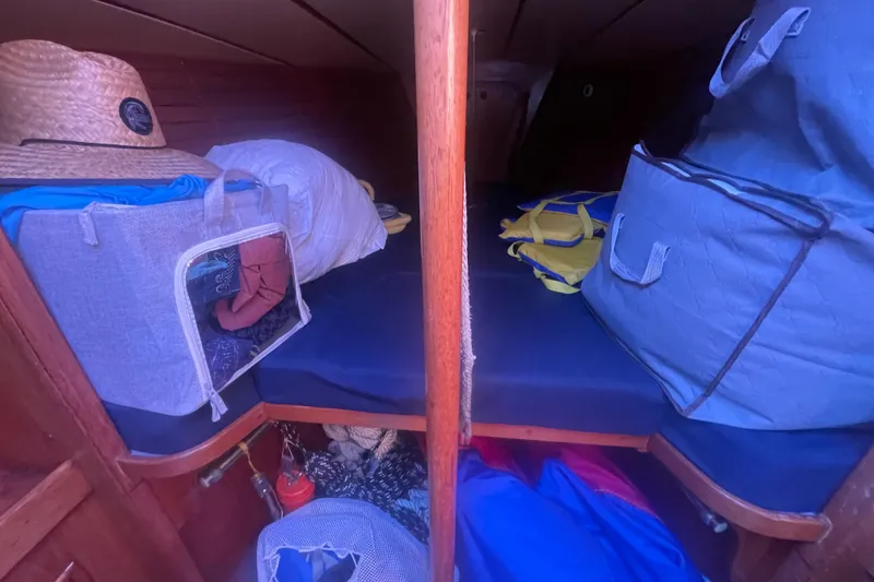 Slide: The Image of Cozy cabin interior of 1981 Nautor Swan cutter with storage bags and a straw hat. - 21