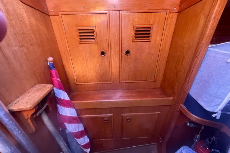 Slide: The Image of Interior of 1981 Nautor Swan cutter with wooden cabinetry and American flag. - 22