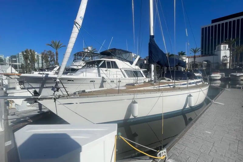 Slide: The Image of 1981 Nautor Swan cutter sailboat docked at marina under clear blue sky. - 3
