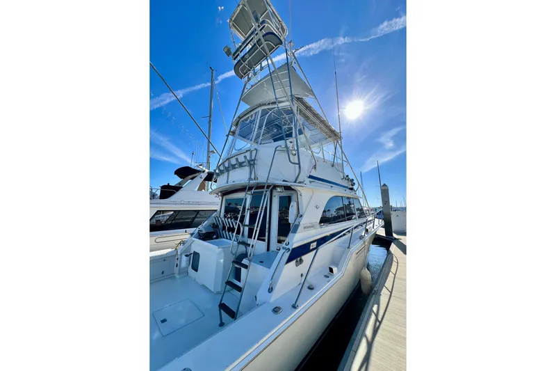 Slide: The Image of 1982 Bertram 46 Convertible yacht docked under clear blue sky. - 12