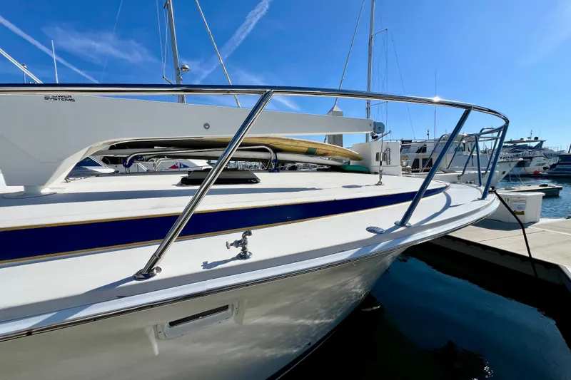 Slide: The Image of 1982 Bertram 46 Convertible yacht docked at marina under clear blue sky. - 19