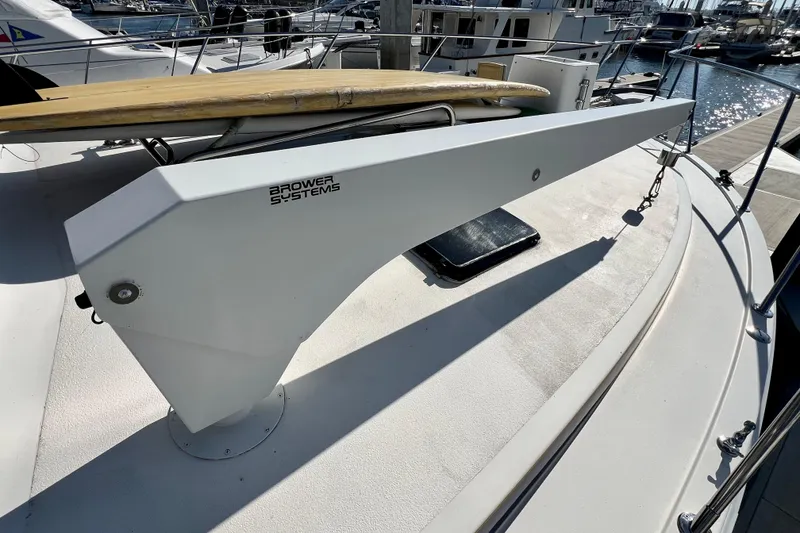 Slide: The Image of Brower Systems crane on 1982 Bertram 46 Convertible yacht deck, docked at marina. - 21
